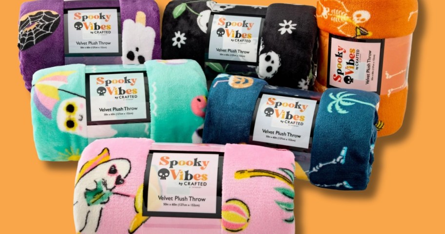 5 rolled up Halloween summer themed throw blankets