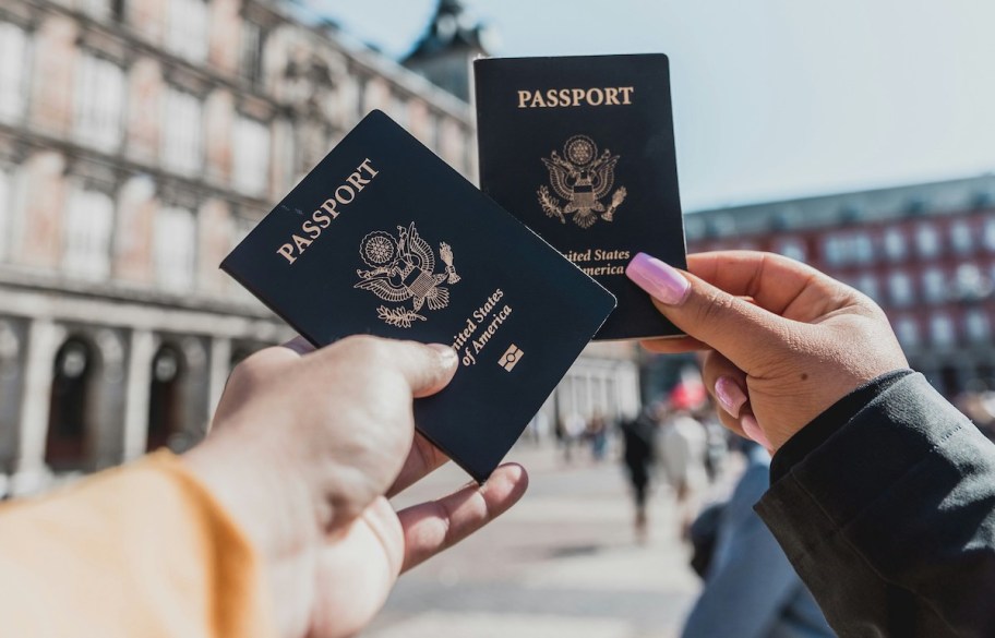 hands holding a passport book in european city
