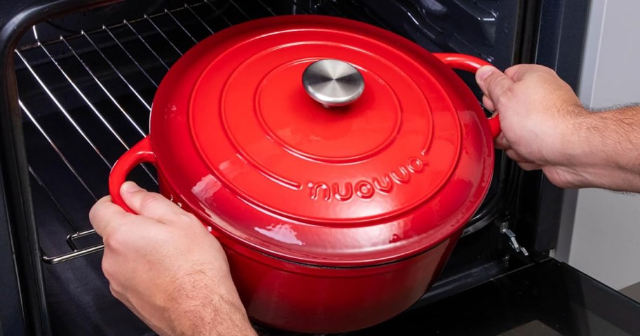 person putting a red dutch over into an over