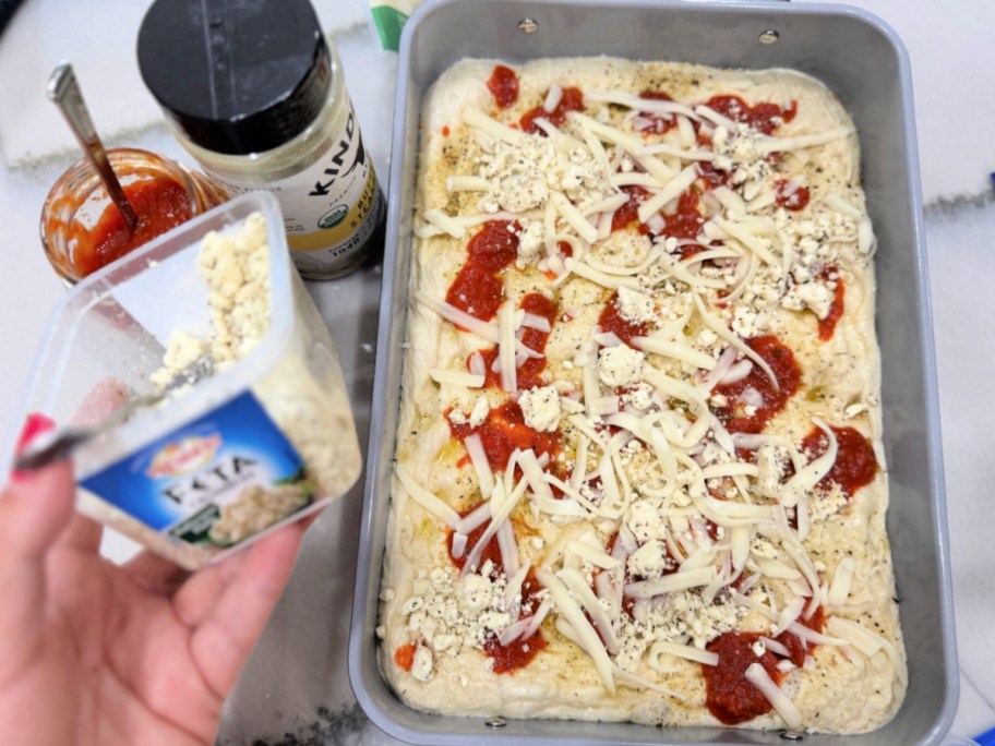 adding feta cheese to easy focaccia bread recipe 
