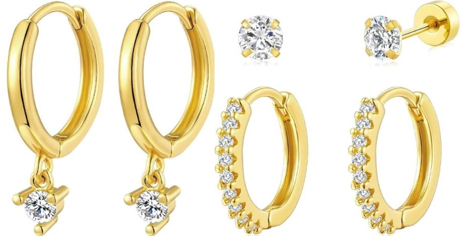 a 3 pair set of gold tone earrings, with a pair of cz huggies, a pair of gold huggies with a cz dangle, and a pair of cz studs